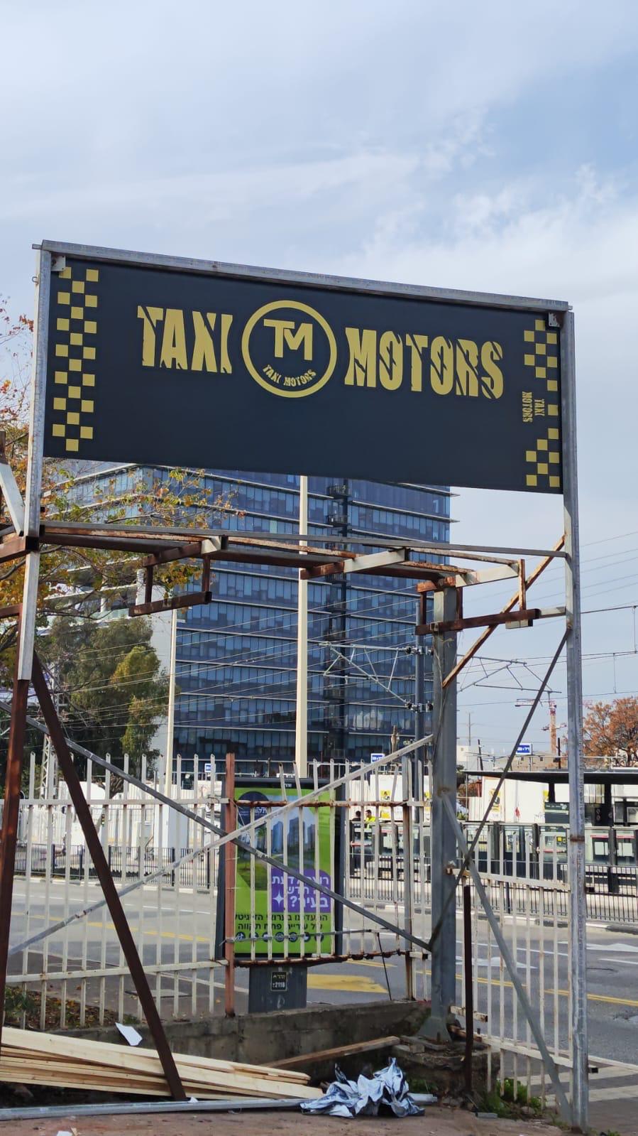 שילוט עסקי מואר של Taxi Motors